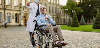 Image - Full length shot of caring young nurse in protective mask taking care of senior man handicapped